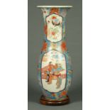 A large Oriental vase, decorated with chrysanthemum and panels of figures,