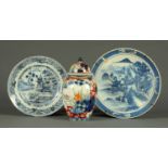 An early 19th century Chinese blue and white plate, decorated with fence and buildings,