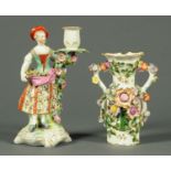 A Victorian floral encrusted vase, together with a Derby figural candlestick. Tallest 24.5 cm.