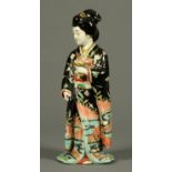 A Japanese porcelain female figure, holding a chalice, polychrome. Height 36 cm (see illustration).