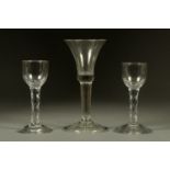 An 18th century moulded foot wine glass, and two antique cordial glasses. Tallest 17 cm.