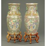 A large pair of Chinese Canton vases, each raised on a wooden stand, last quarter 20th century.