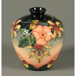 A Moorcroft vase, impressed "Moorcroft Made in England" and with green initials. Height 18 cm.