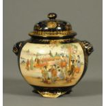 An early 20th century Satsuma jar and cover, decorated with panels of figures. Height 20 cm.