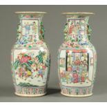 A pair of 19th century Canton Famille Rose vases, decorated with panels of figures.
