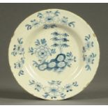 A late 18th century English Delft plate, blue and white floral patterned.