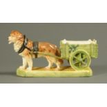 A Royal Dux figure, dog pulling cart. Length 34 cm.