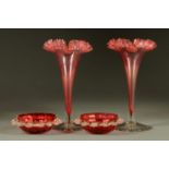 A pair of Victorian cranberry glass spill vases, and a pair of cranberry bonbon dishes.