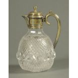 A cut glass claret jug, with silver plated mount.