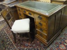 A Victorian oak nine drawer pedestal desk with a green leather inset top,
