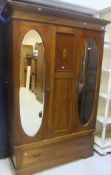 An Edwardian mahogany and inlaid double mirror door wardrobe with drawer on bracket feet