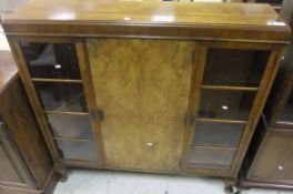 A mahogany bookcase with two glazed doors enclosing four shelves above two cupboard doors on