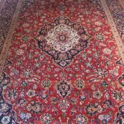 A Kashan carpet, the central floral medallion in pale blue, red,