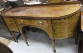 A late Regency mahogany sideboard with galleried back over a rosewood strung top with single bow end
