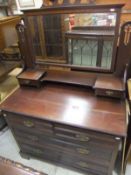 An Edwardian mahogany dressing chest of two short and two long drawers with brass handles and bevel