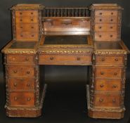 A Victorian Gothic Revival oak desk with drawers to superstructure above a writing slope,