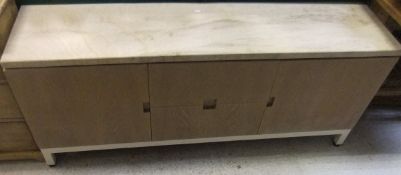 A polished stone topped sideboard of two doors and two drawers on a cream painted iron base