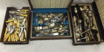 Three boxes containing assorted cutlery, together with a nest of three tables,