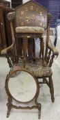 A 19th Century Windsor type elbow chair, raised on turned and ringed legs united by stretchers,