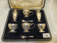 A George V silver cased cruet set comprising peppers, salts and mustards (by Mappin & Webb,