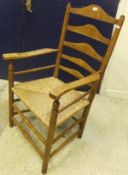 A 19th Century ash ladder back rush seat elbow chair