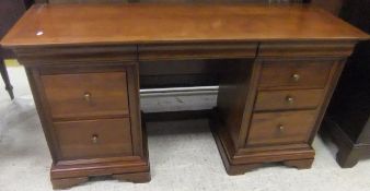 A modern cherrywood pedestal dressing table with loose triple dressing mirror