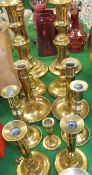 A collection of six pairs of brass candlesticks, to include telescopic examples,