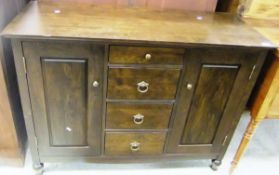 A Marks & Spencer sideboard, the plain top over four short drawers flanked by two cupboard doors,