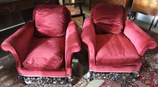 A pair of Carolean style deep seated armchairs with carving to the legs and front stretcher, with
