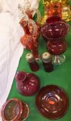 A collection of cranberry glassware to include two liqueur decanters, two sugar shakers, water jug,