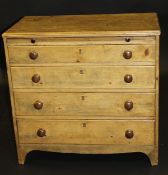 A 19th Century pine bachelor's chest of four long graduated drawers with brush slide,