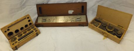 Two wooden cases containing various brass weights,