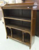 A Victorian walnut open bookcase with three quarter galleried top over three shelves