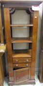 A mahogany three shelf display cabinet above two drawers and cupboard door below