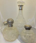 A pair of Victorian cut glass and silver mounted scent bottles, together with a further scent bottle