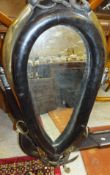 A leather horse collar as a frame for a mirror