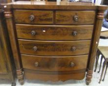A Victorian bow fronted figured mahogany chest of two short over three long graduated drawers