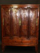 A late 20th Century Chinese lacquered hardwood wardrobe / hall cupboard,