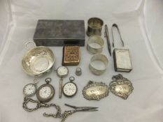A box containing assorted silver and plated wares to include napkin rings,