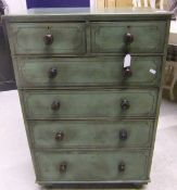 A small painted pine chest of two short over four long graduated drawers, raised on turned feet