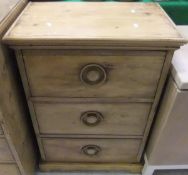 A pine three drawer chest on plinth base