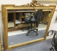 A gold painted rectangular wall mirror with moulded frame and another smaller mirror