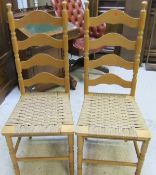 Five beech ladder back dining chairs with string seats