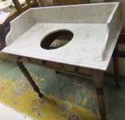 A Victorian marble topped wash stand with three quarter galleried top and recess for bowl on a