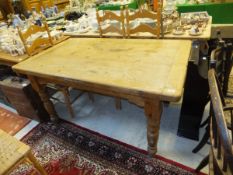 A rectangular pine farmhouse kitchen table on turned legs