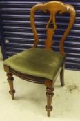 A set of four Victorian mahogany dining chairs, the shaped backs over drop-in seats,