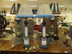 A pair of patinated metal table lamps in the form of 17th Century Dutch pricket holders,