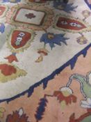 A Turkish carpet, the central diamond shaped medallion in cream, terracotta,