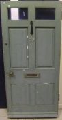 A painted hardwood exterior door bearing number "19"