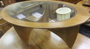 A G-Plan teak coffee table of oval form with glass insert top